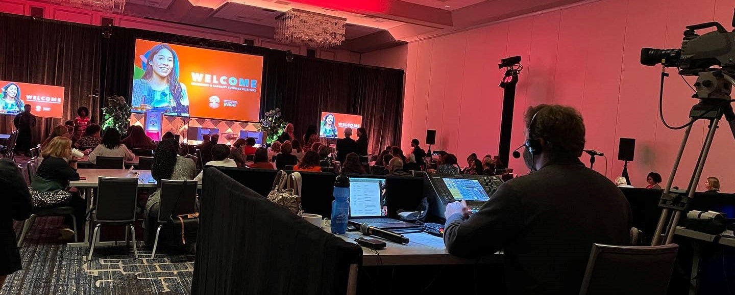 Conference room with people and a person with a lights mixer