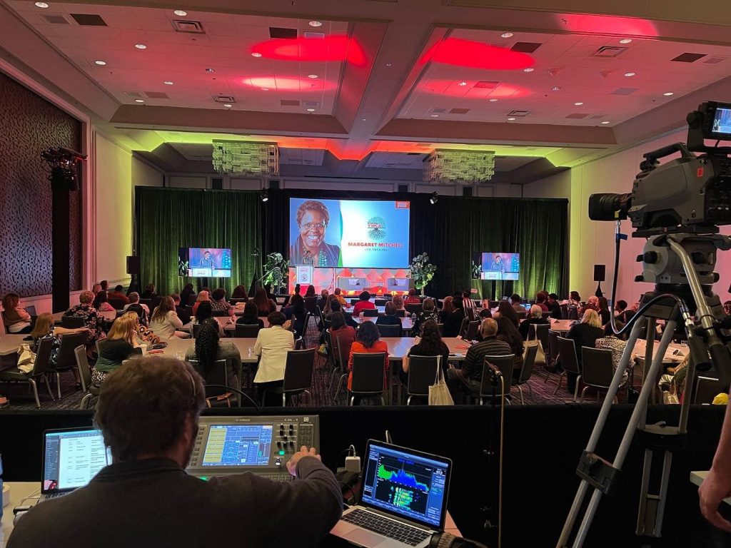 Full conference room for YWCA event, video equipment recording